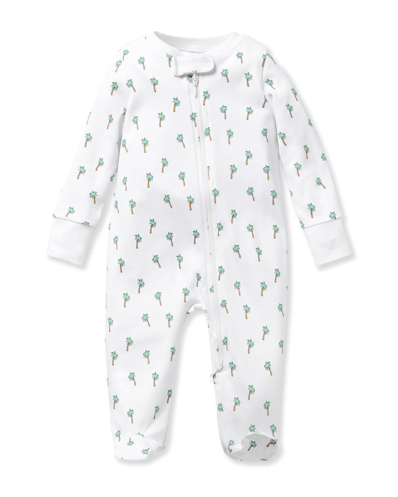 Petite Plumes Babys Pima Romper in Palmier boasts long sleeves, a front zipper, and is crafted from soft Pima cotton with a vibrant pattern of green palm trees and brown trunks.