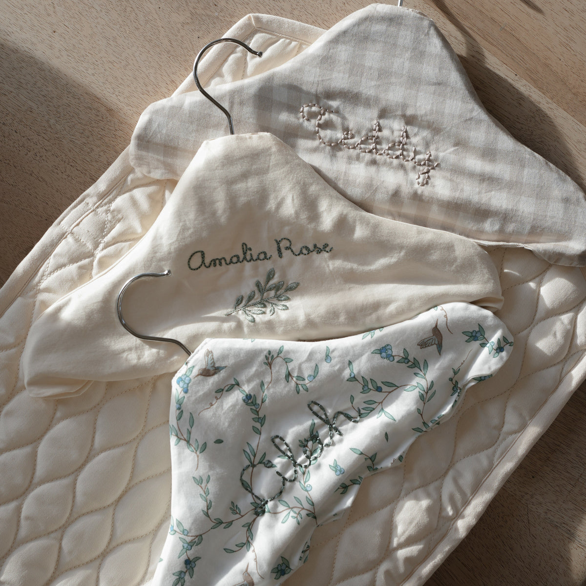 Children's Hanger in Secret Garden, Ivory and Beige Gingham laying flat on table