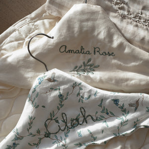 Children's Hanger in  Secret Garden, Ivory and Beige Gingham laying flat on table