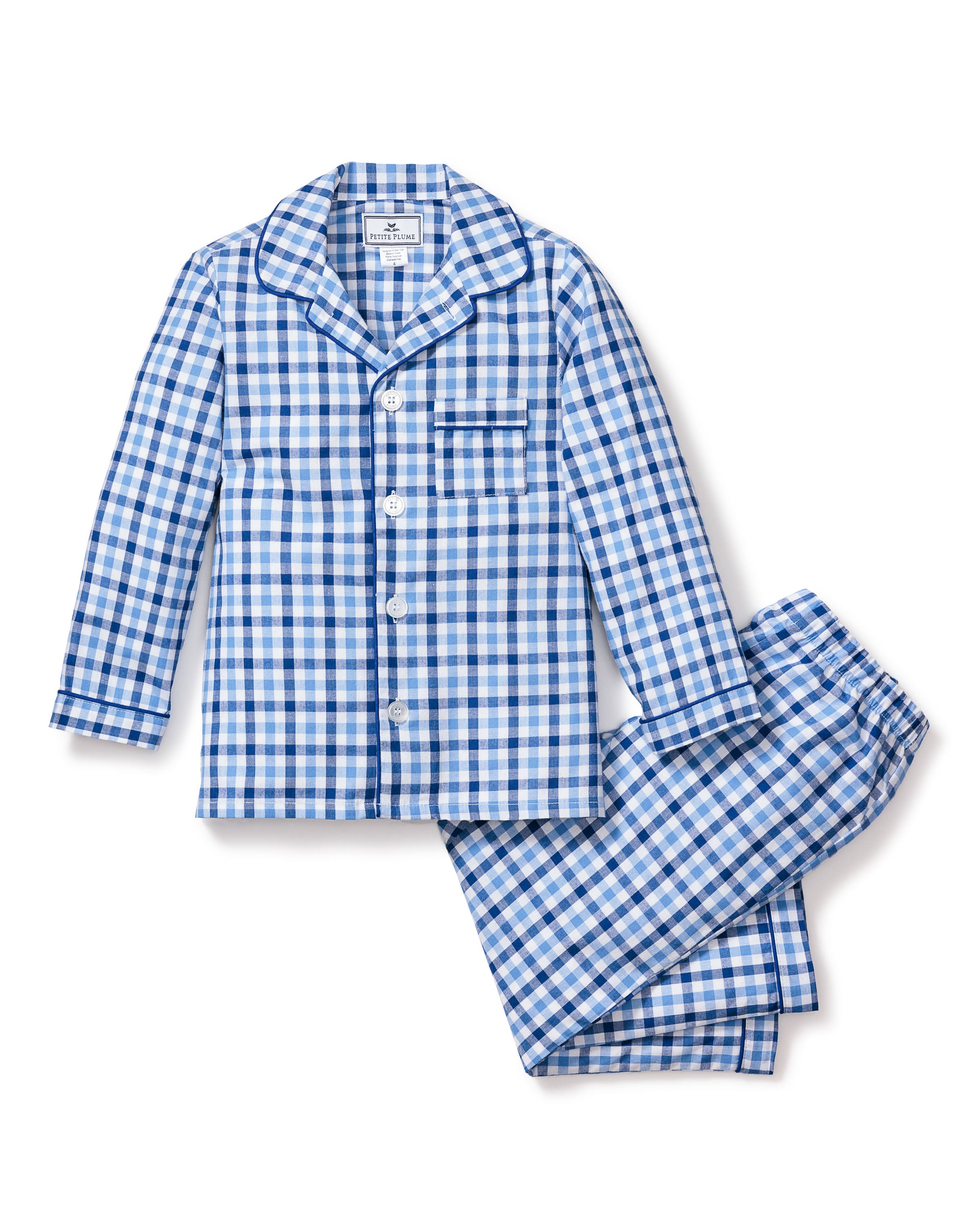 The Kids Twill Pajama Set by Petite Plume in Royal Blue Gingham features a long-sleeve button-up top with a chest pocket and matching pants. Its classic gingham print and pointed collar offer style and comfort for a restful nights sleep.