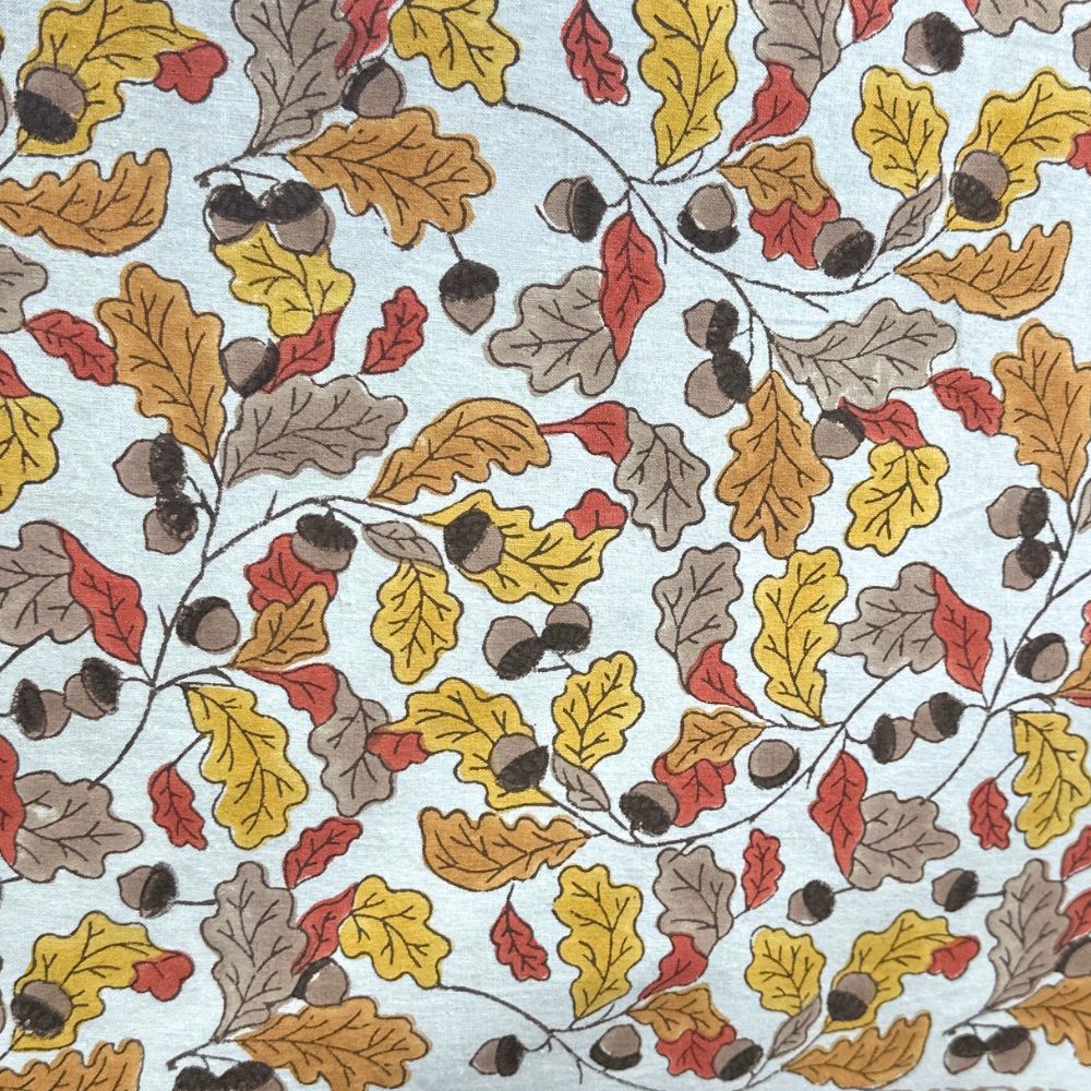 Pattern of autumn leaves and acorns on a white background