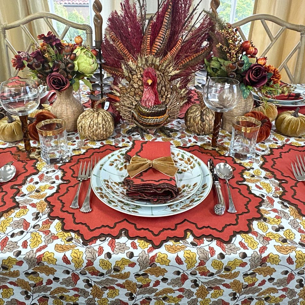 Fall Table Linens Pumpkin Whitley luxury placemat and napkin on acorn leaves tablecloth with gold napkin bow and Thanksgiving china.