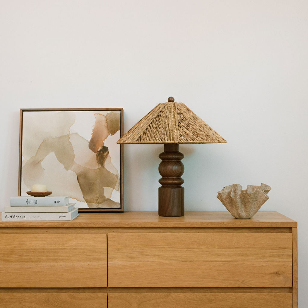 table lamp on dresser next to books