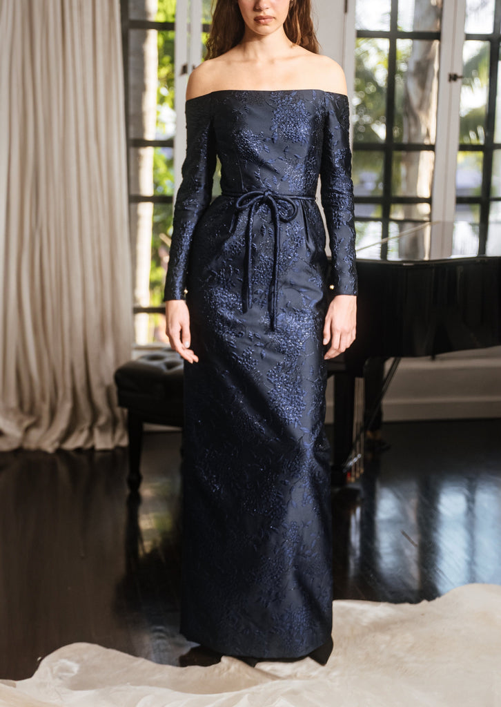 Off-The-Shoulder Long Sleeve Waisted Gown Cinched With Corded Belt In Navy French Brocade