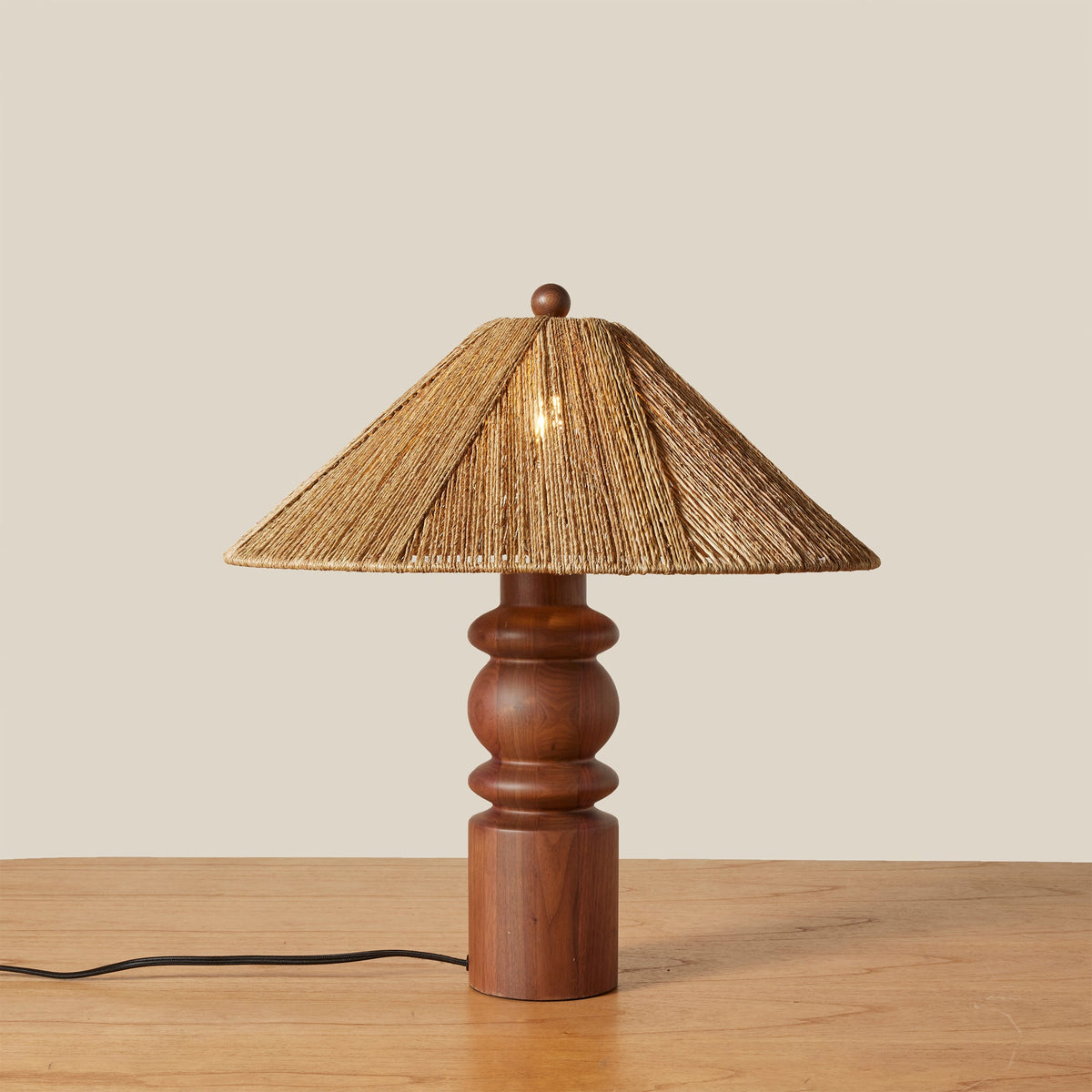 wood and jute table lamp with light on