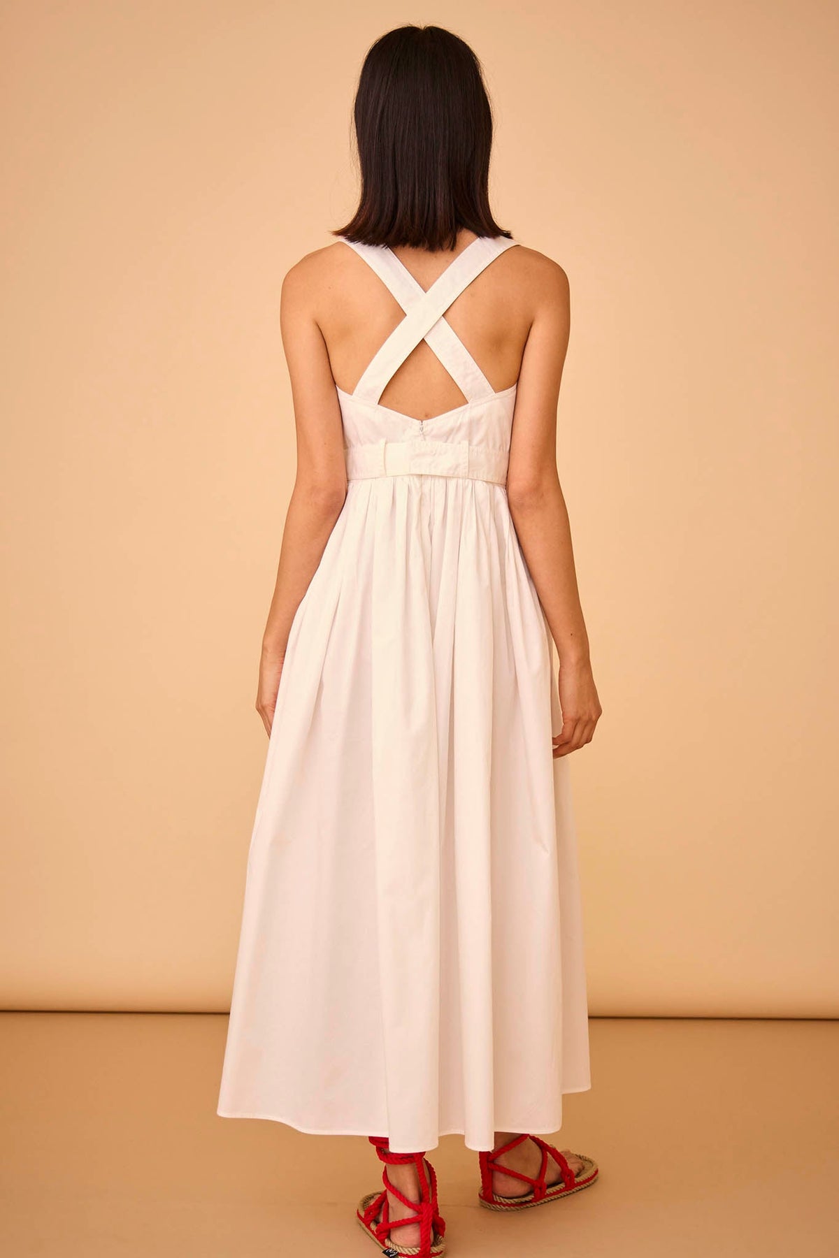 The Cleo Dress has a tank-style bodice, adjustable cross-back straps, and side seam pockets.