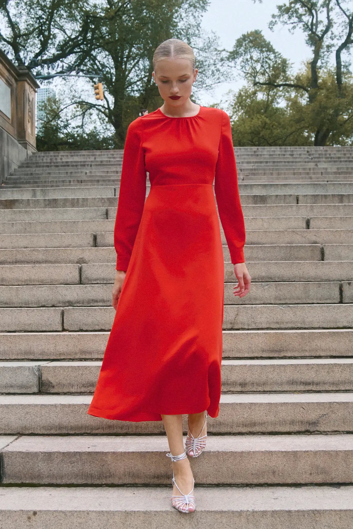The Delancey Dress is long-sleeve with a shirred round neckline, banded cuffs, and a full skirt.