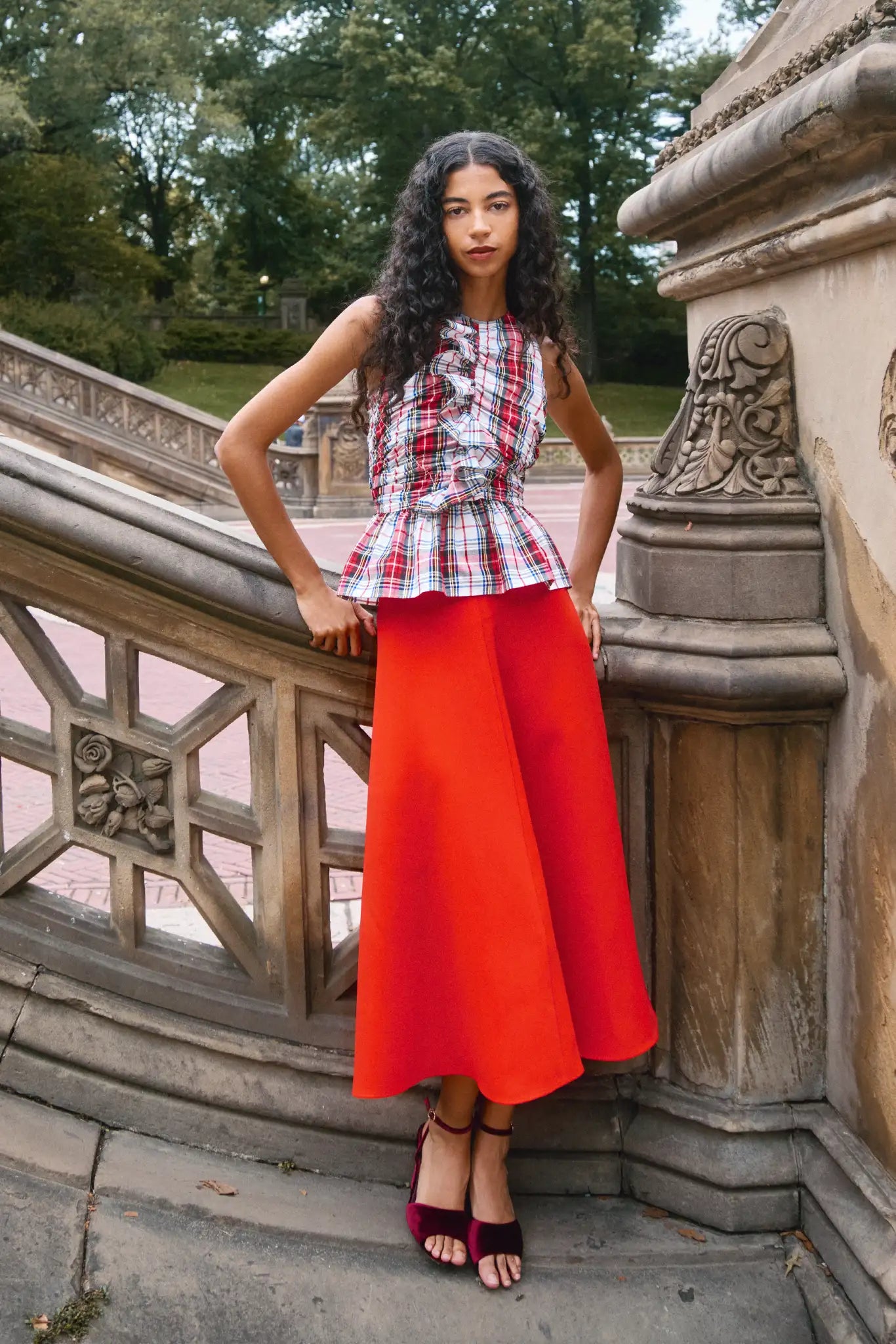 The Doering Top is a fitted V-neck silhouette with ruffles, shirring, and a peplum waist. 