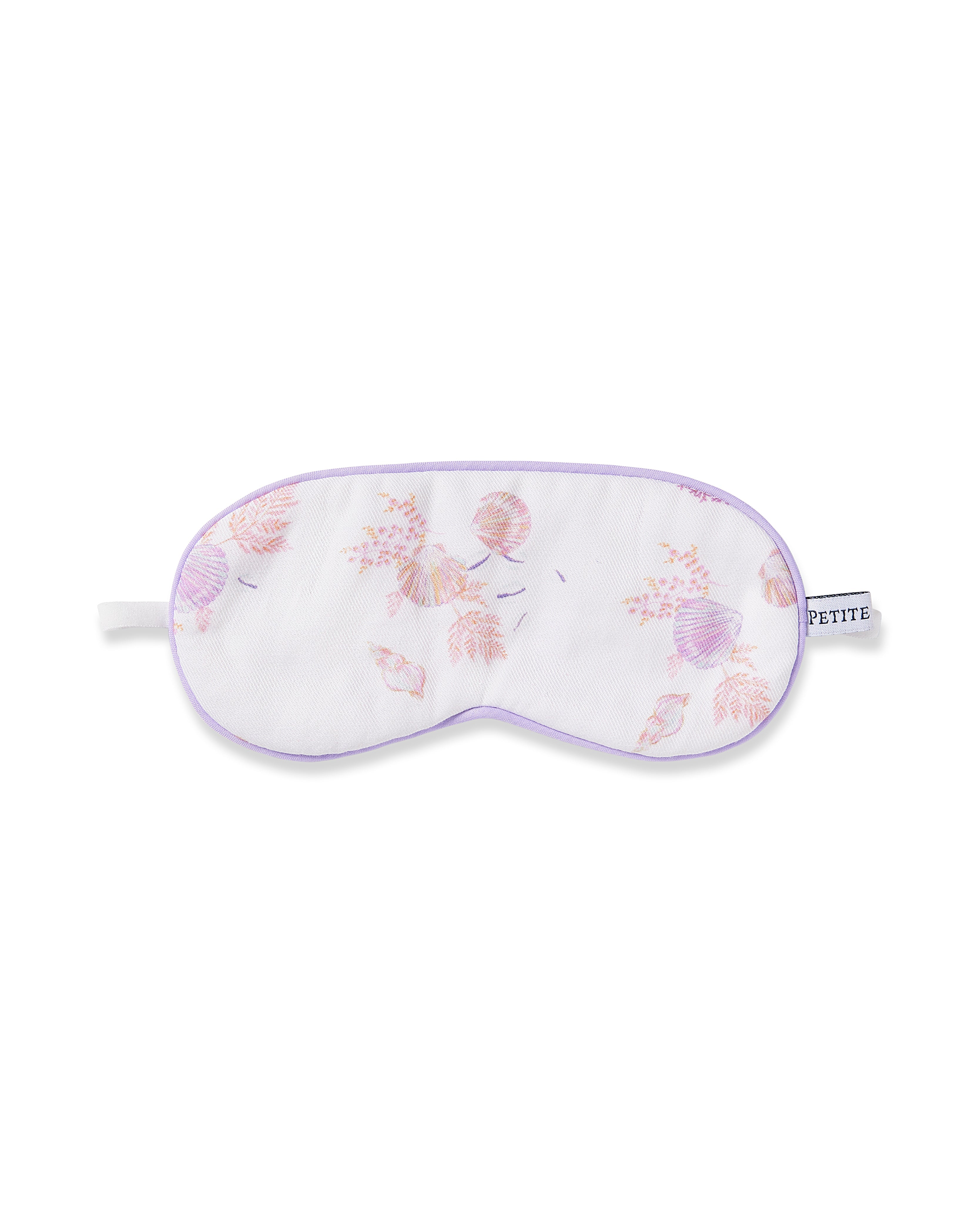 The Kids Twill Sleep Mask in Seashell Splendor by Petite Plume features a white design with a soft purple border and small floral patterns in pastel pink and purple. A side tag reads PETITE, making it perfect for those who value intricate details in their bedtime accessories.