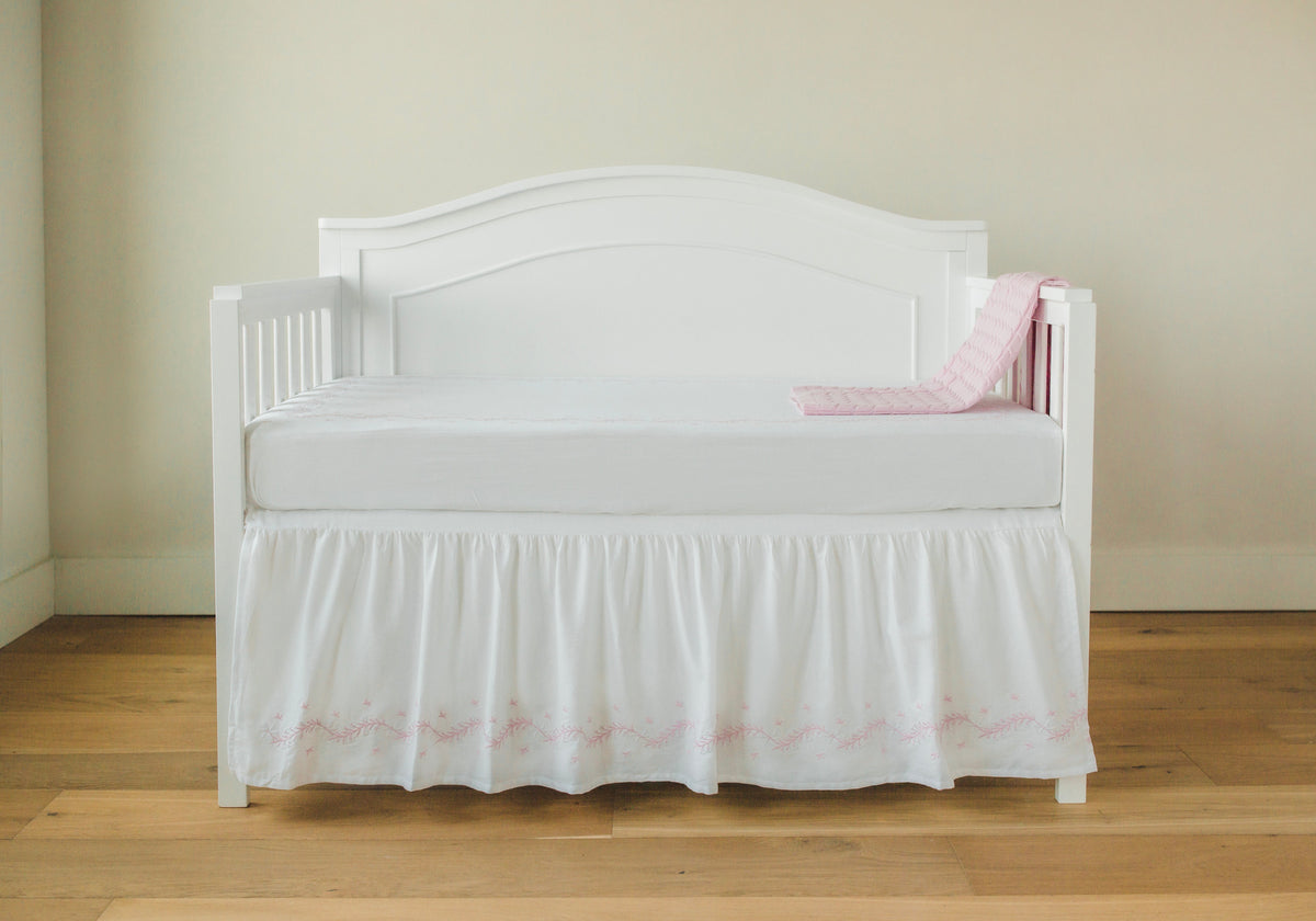 Little English classic nursery goods for baby, white crib skirt with simple light pink embroidery along the edges for baby