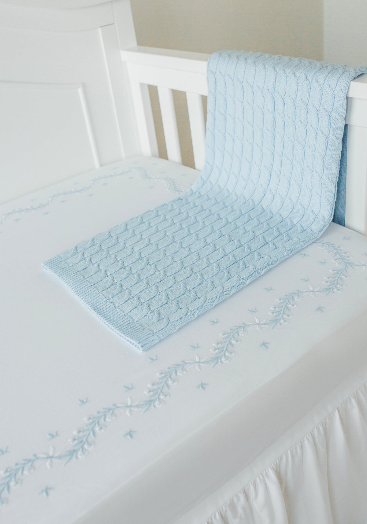 Little English classic nursery goods for baby, white crib sheet with simple light blue embroidery along the edges for baby