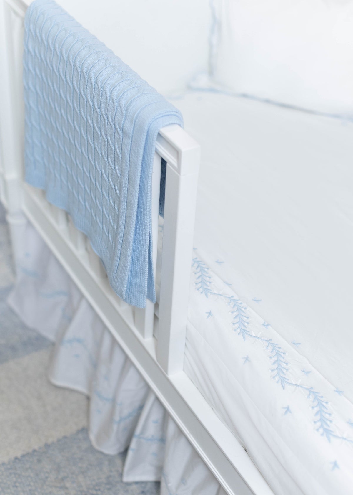 Little English classic nursery goods for baby, white crib sheet with simple light blue embroidery along the edges for baby