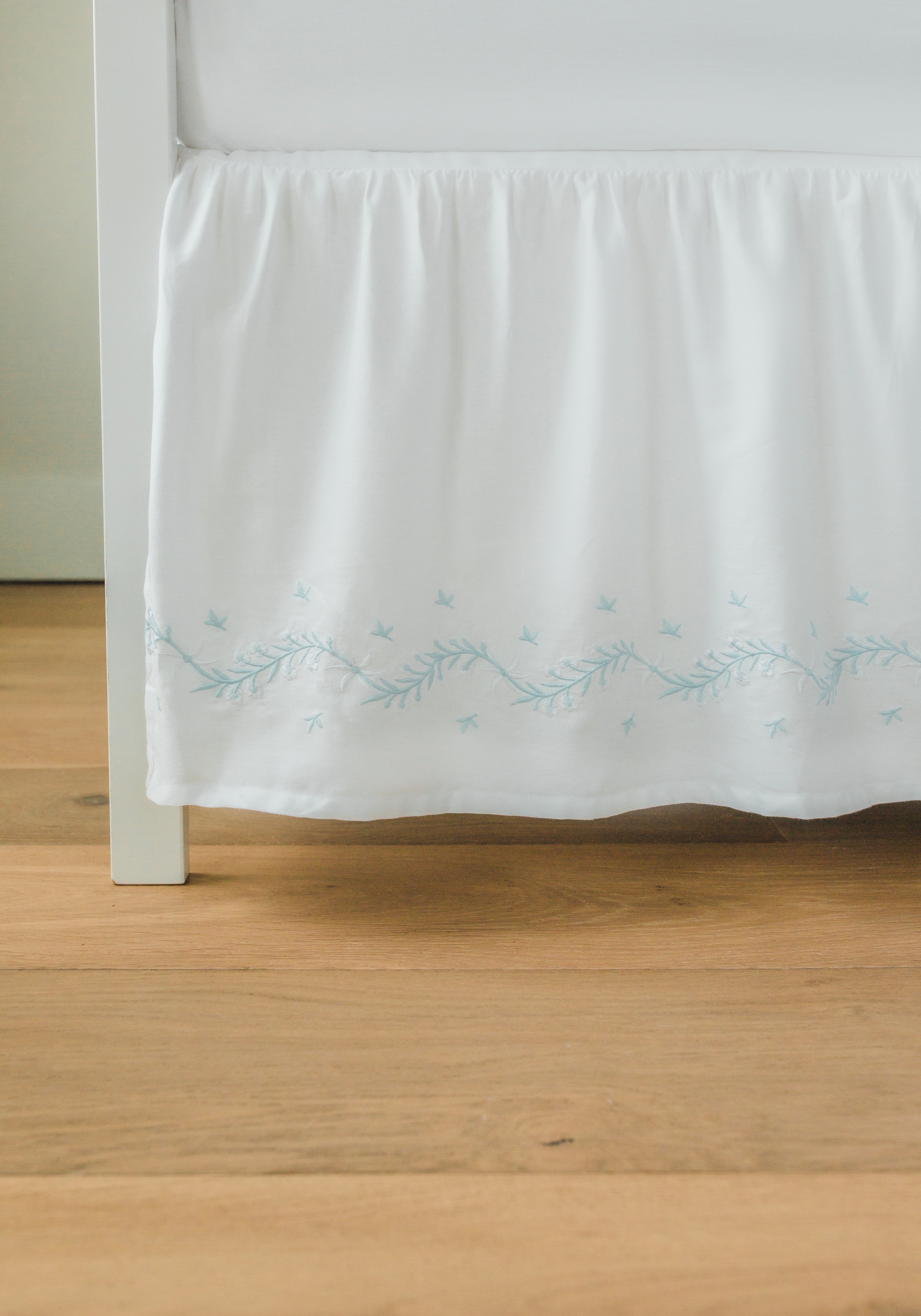 Little English classic nursery goods for baby, white crib skirt with simple light blue embroidery along the edges for baby