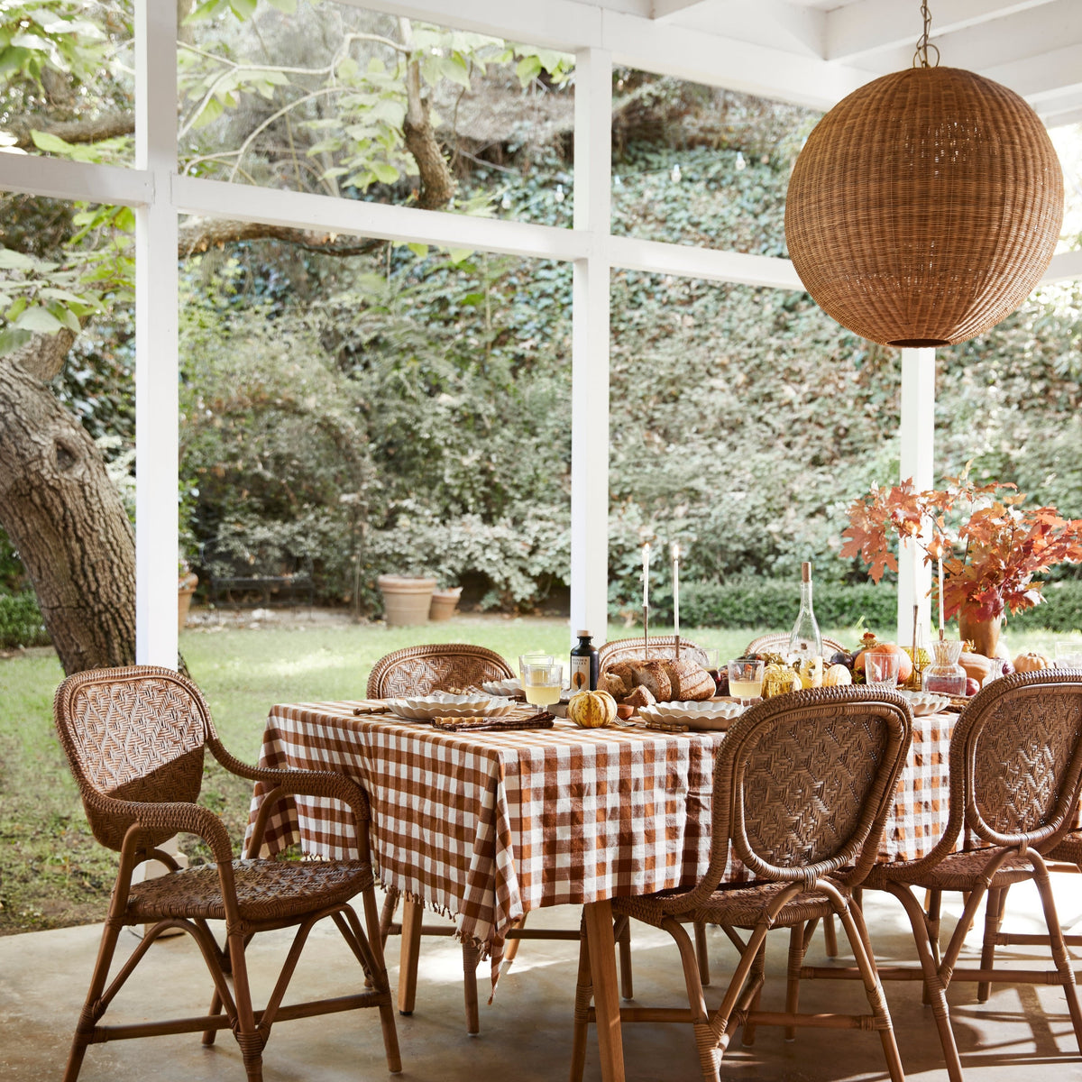table with chairs inside porch with round chandelier