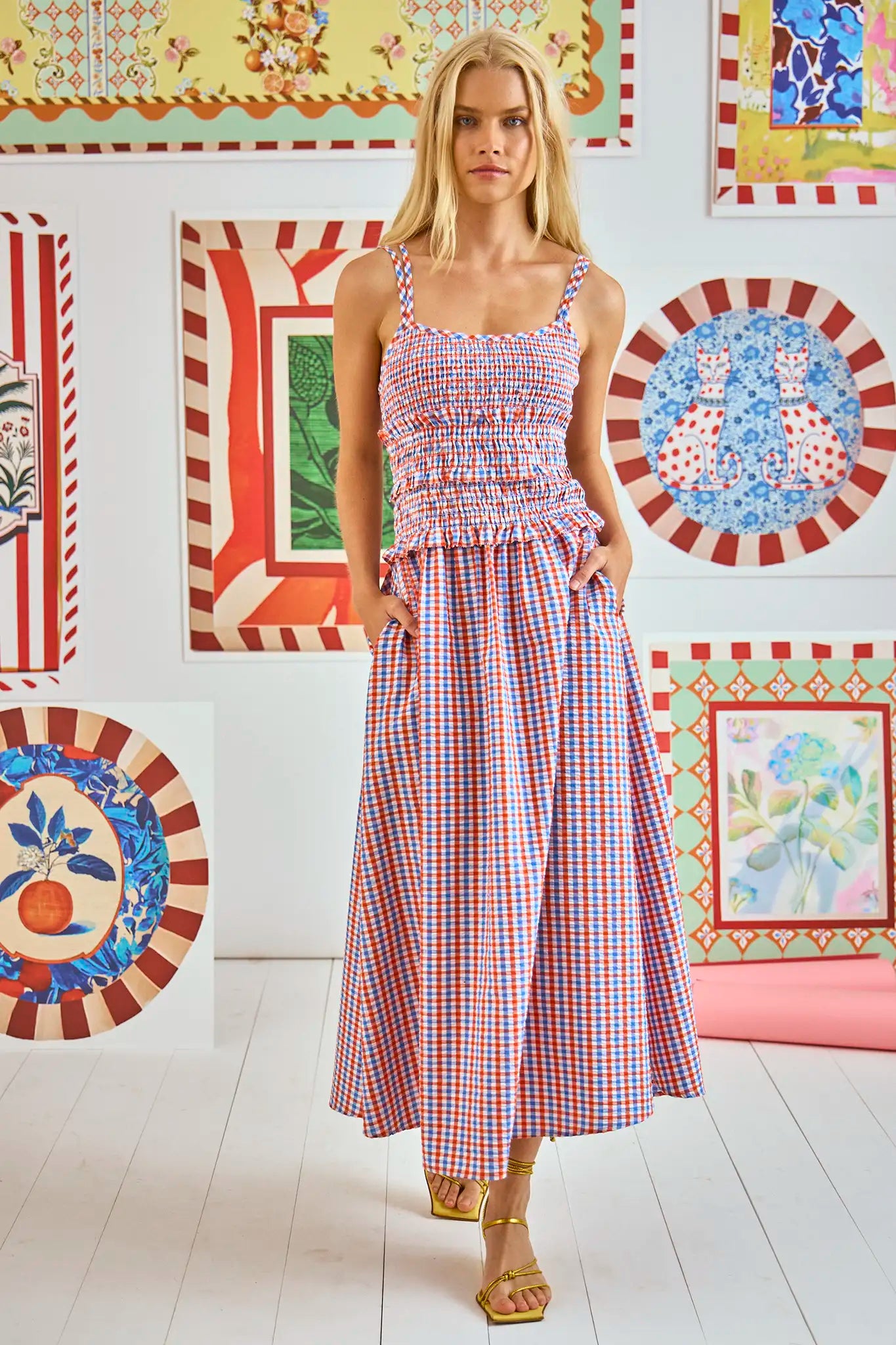 The Francie Dress has a cami neckline, double straps, a smocked bodice and a full, shirred skirt.