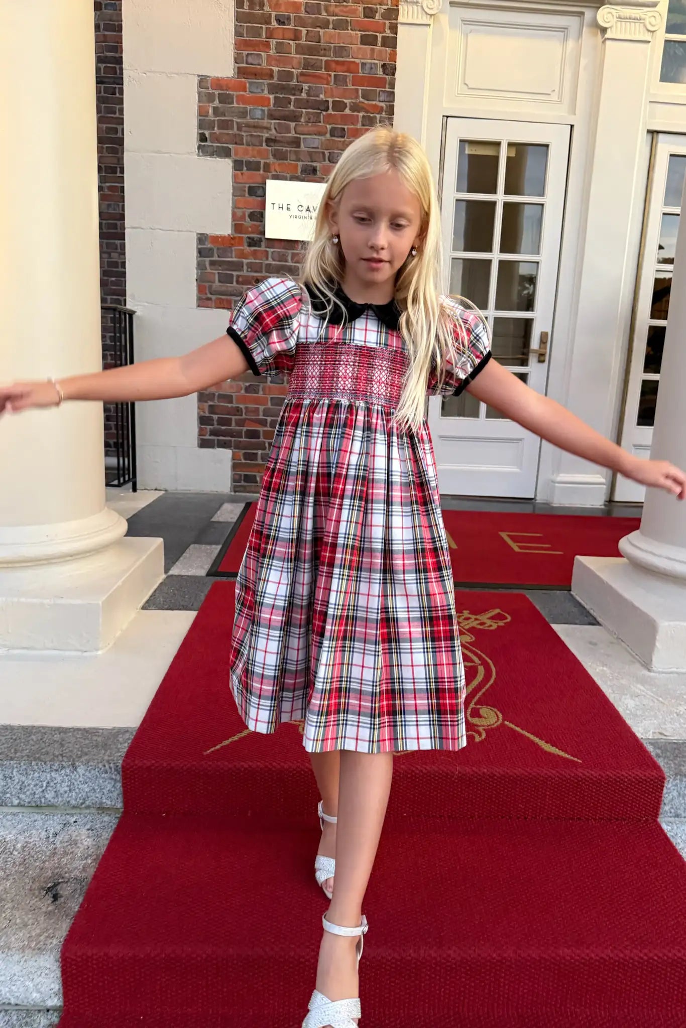 The Joy Kids Dress has a black velvet Peter Pan collar, smocked bodice, and puff short sleeves.