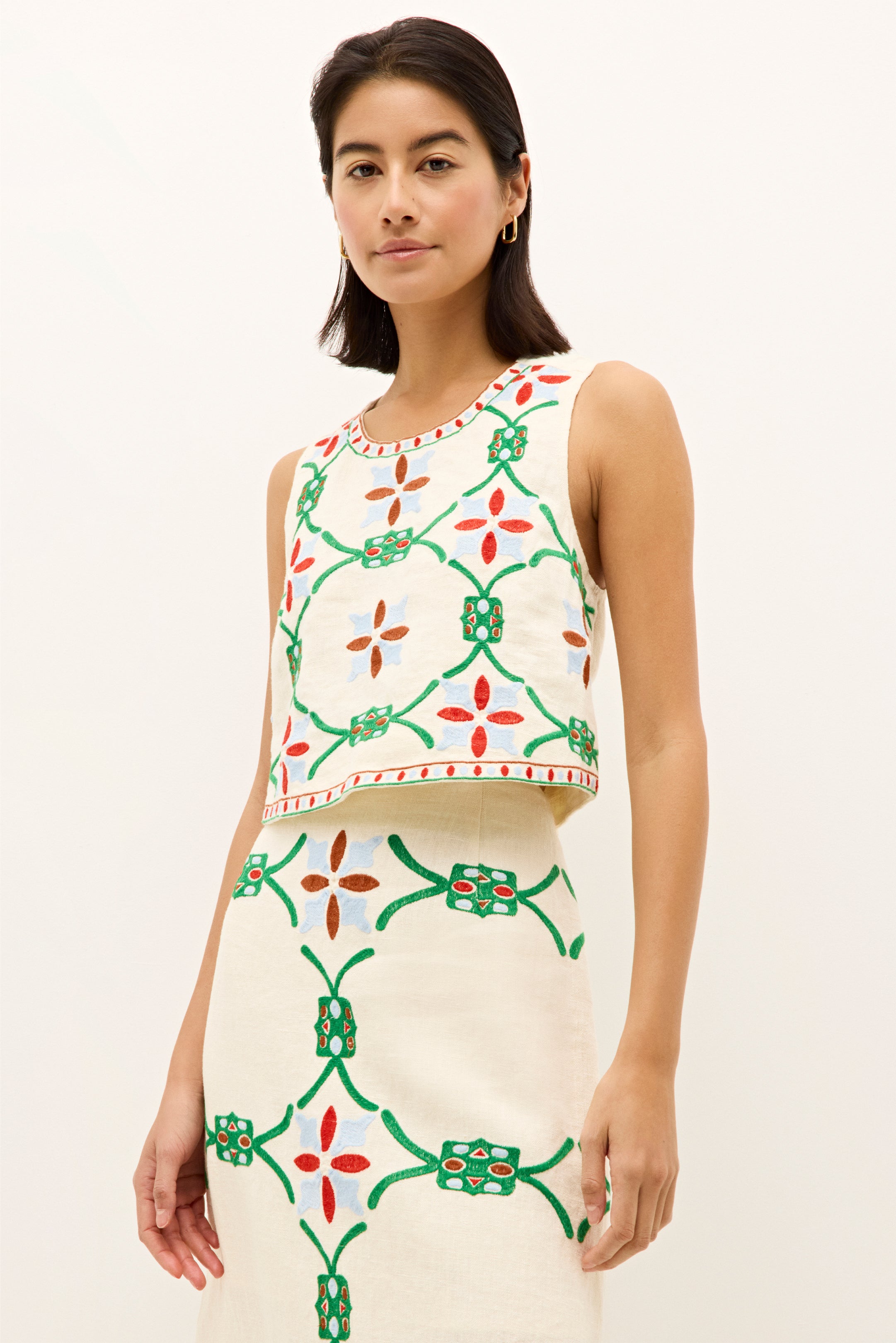 Ivory sleeveless top with bold multicolor geometric embroidery
