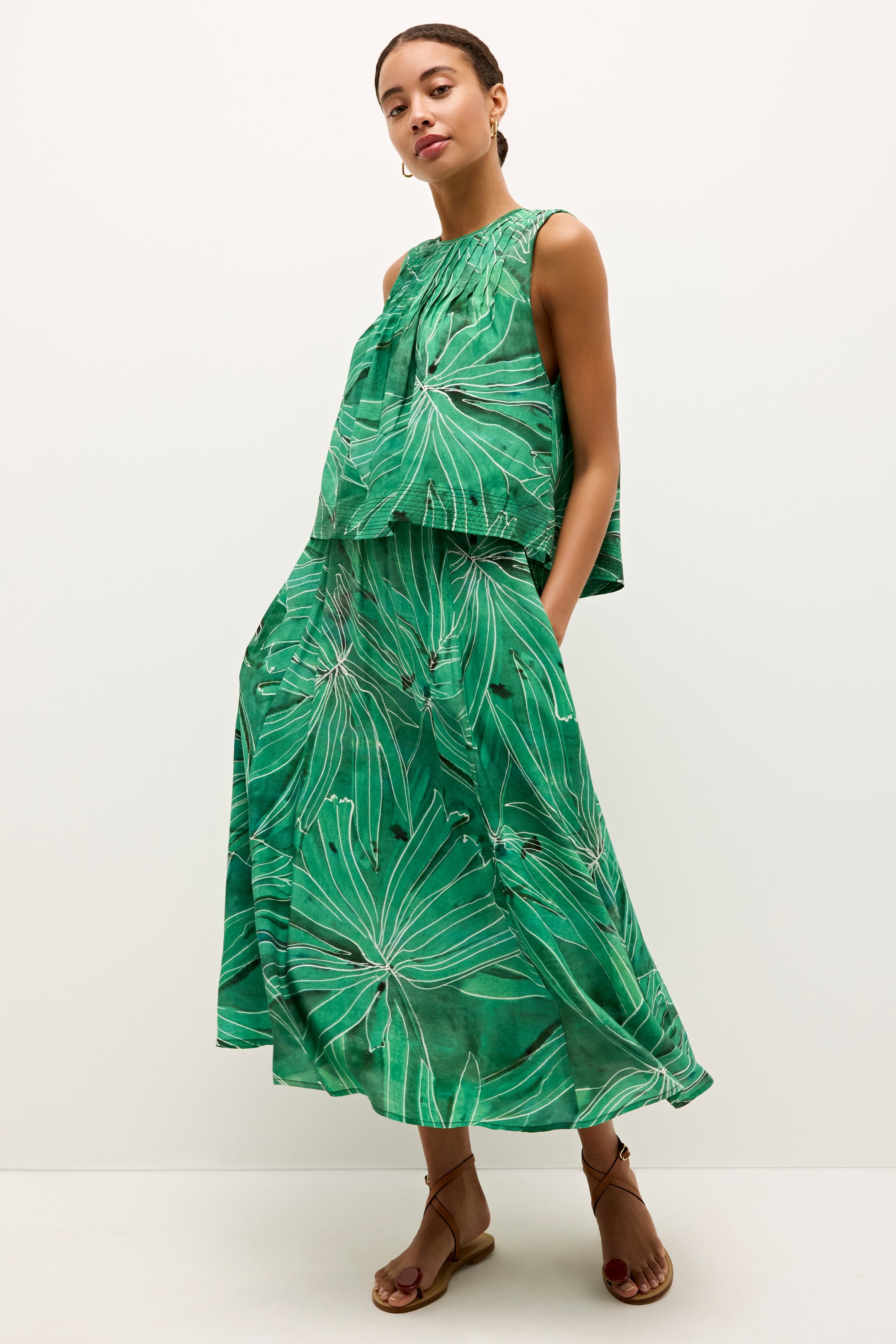 Green midi skit with tropical leaf print and full A-line silhouette