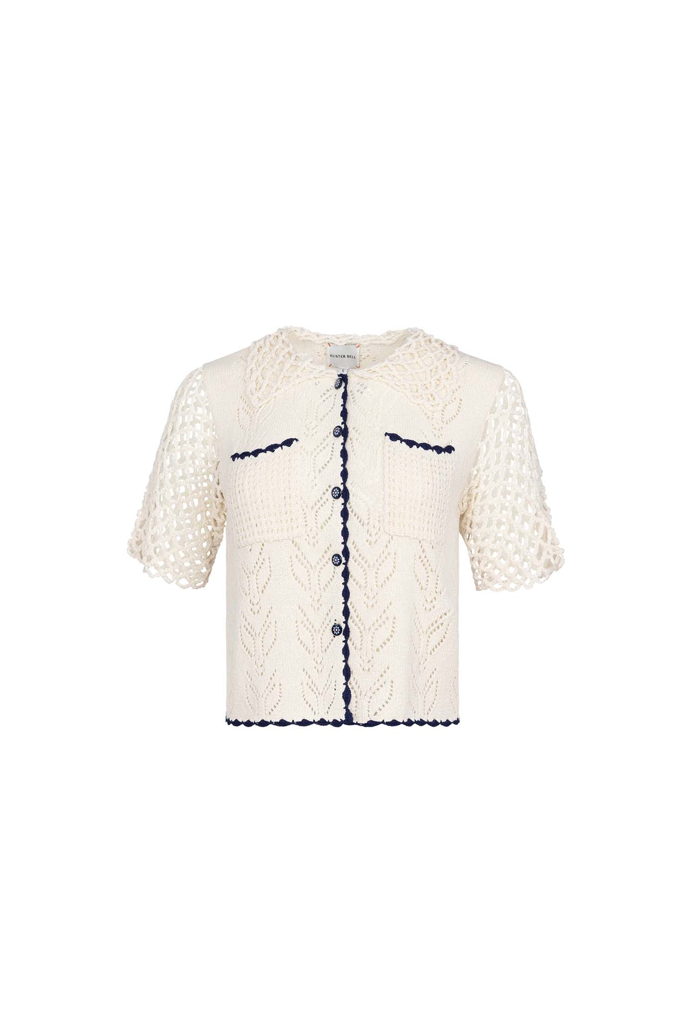 The Ophelia Sweater has short sleeves, novelty painted flower buttons, and scalloped edging.