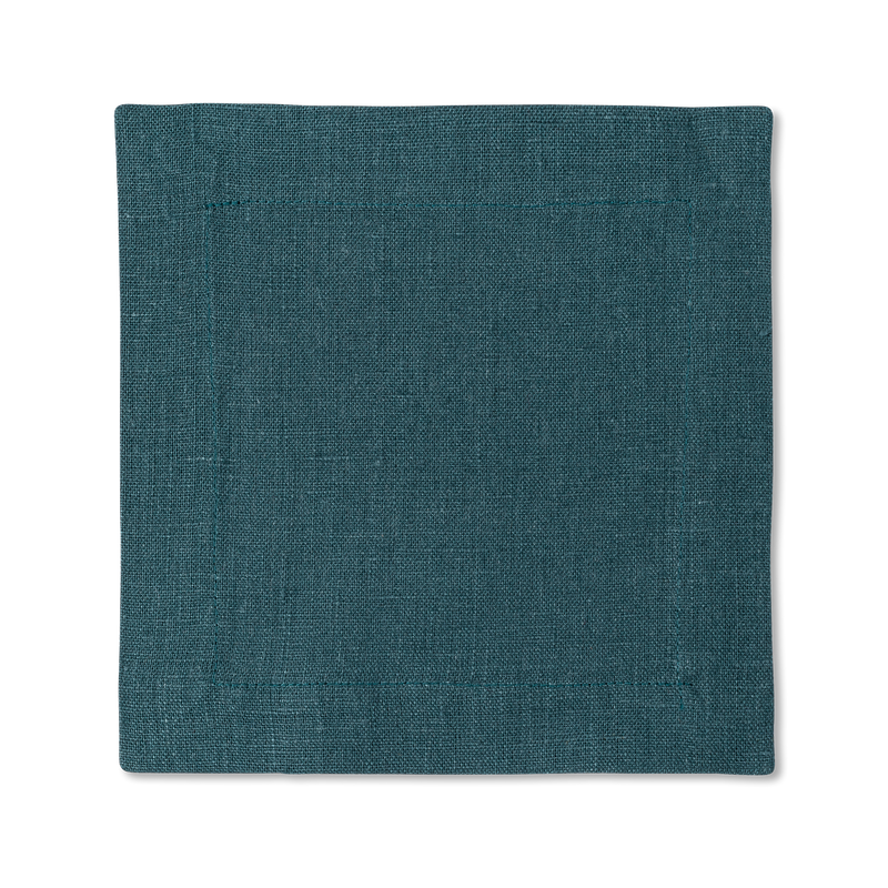 A square linen cocktail napkin in the color peacock