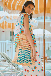 A hand crochet raffia tote has an Amalfi Tiles print scarf handle and signature HB stitching.