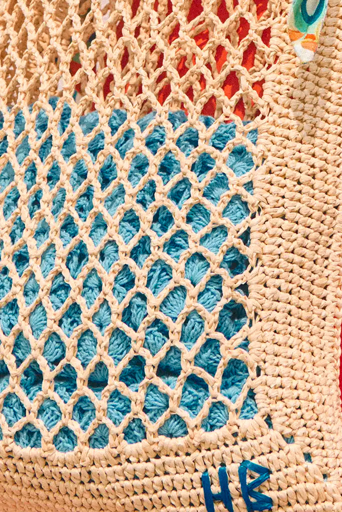 A hand crochet raffia tote has an Amalfi Tiles print scarf handle and signature HB stitching.