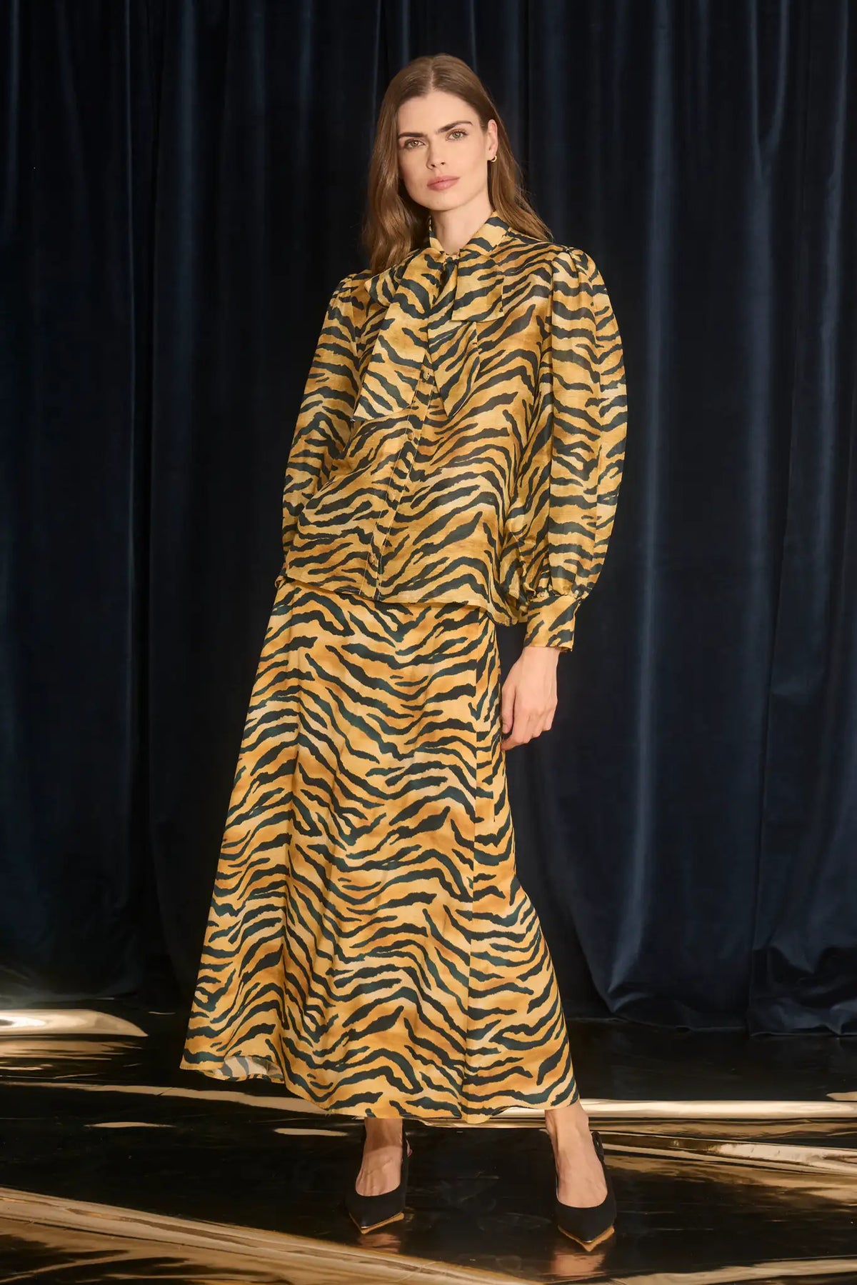 The Tess Blouse in Tiger print, has an elegant tie-front neckline that can be styled into a bow.