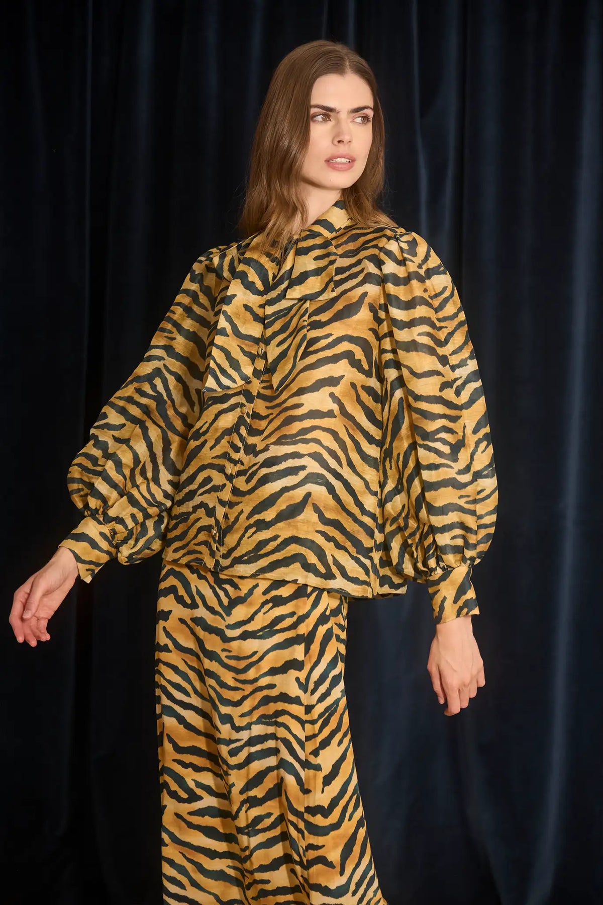 The Tess Blouse in Tiger print, has an elegant tie-front neckline that can be styled into a bow.