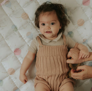 Touch the sky playmat in pink. Baby is laying on play mat 