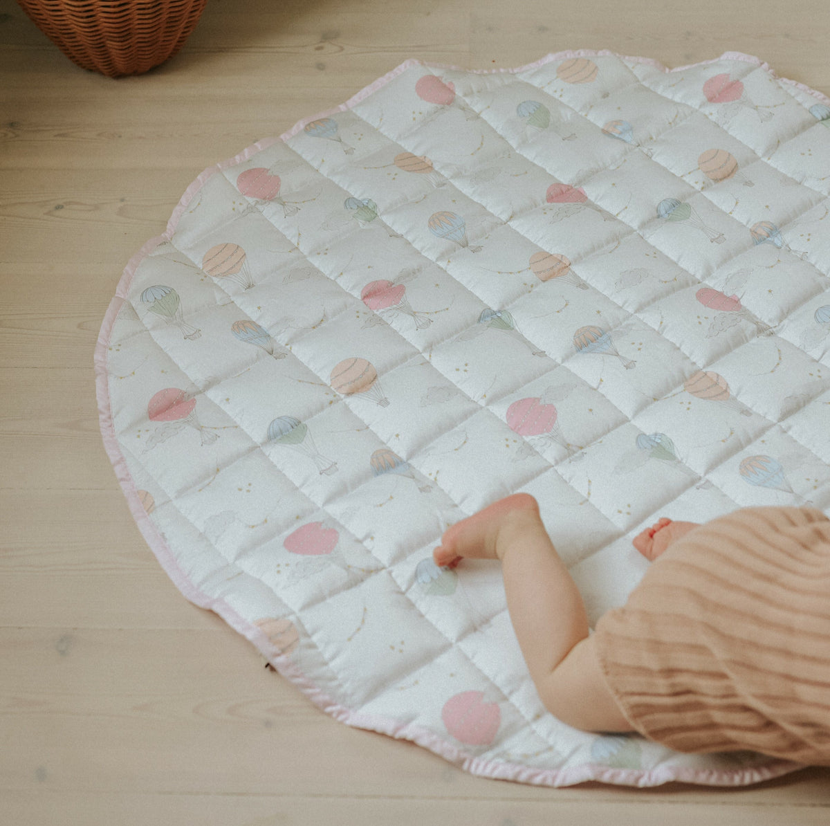 Touch the sky play mat in pink. Baby crawling off play mat