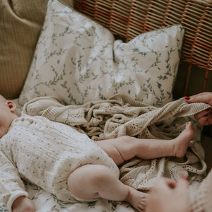 Baby playing with Mother, with the Toddler Pillow in the "Secret Garden" print in the background in the ivory color