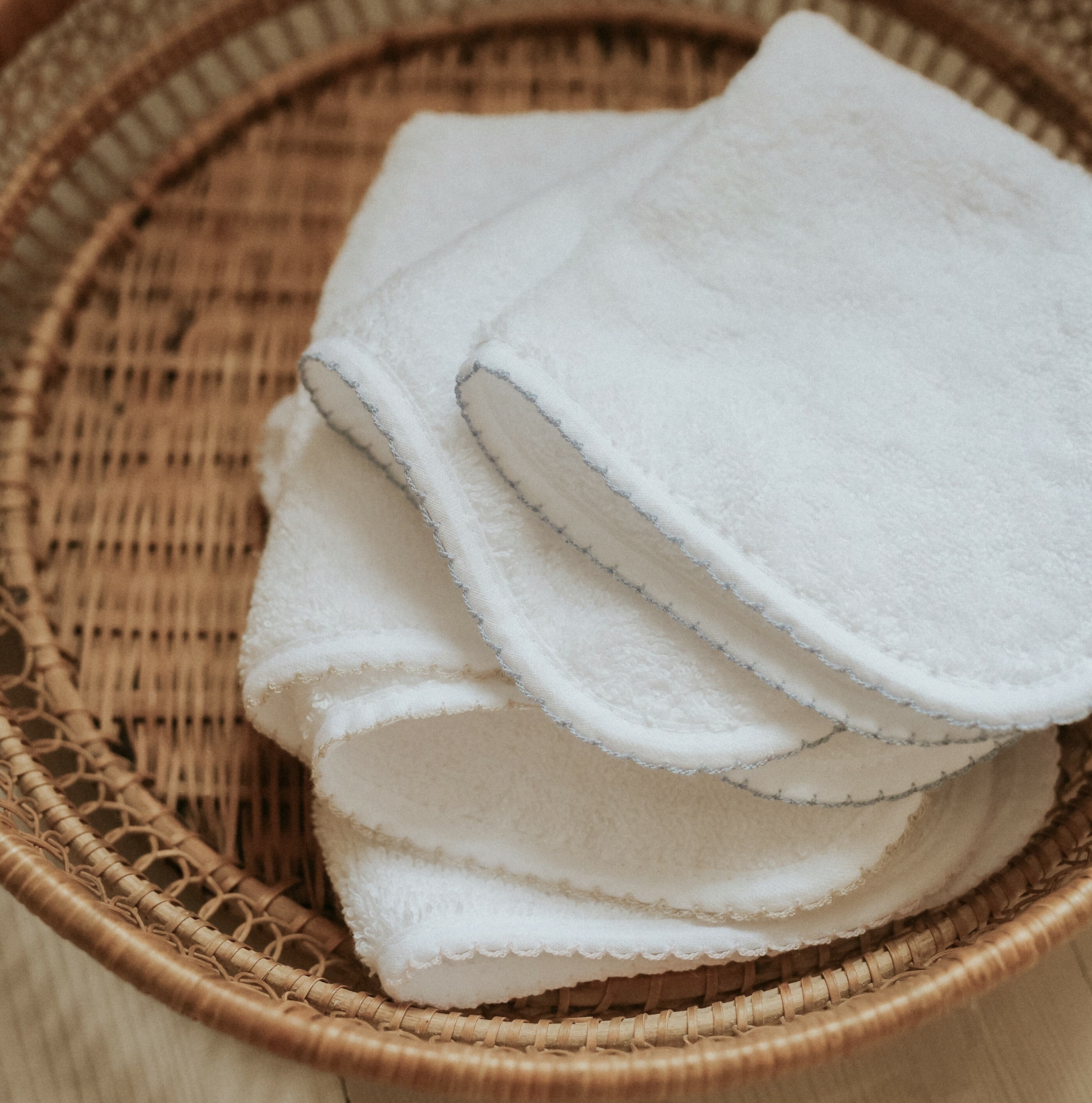 Classic washcloths folded in a rattan basket