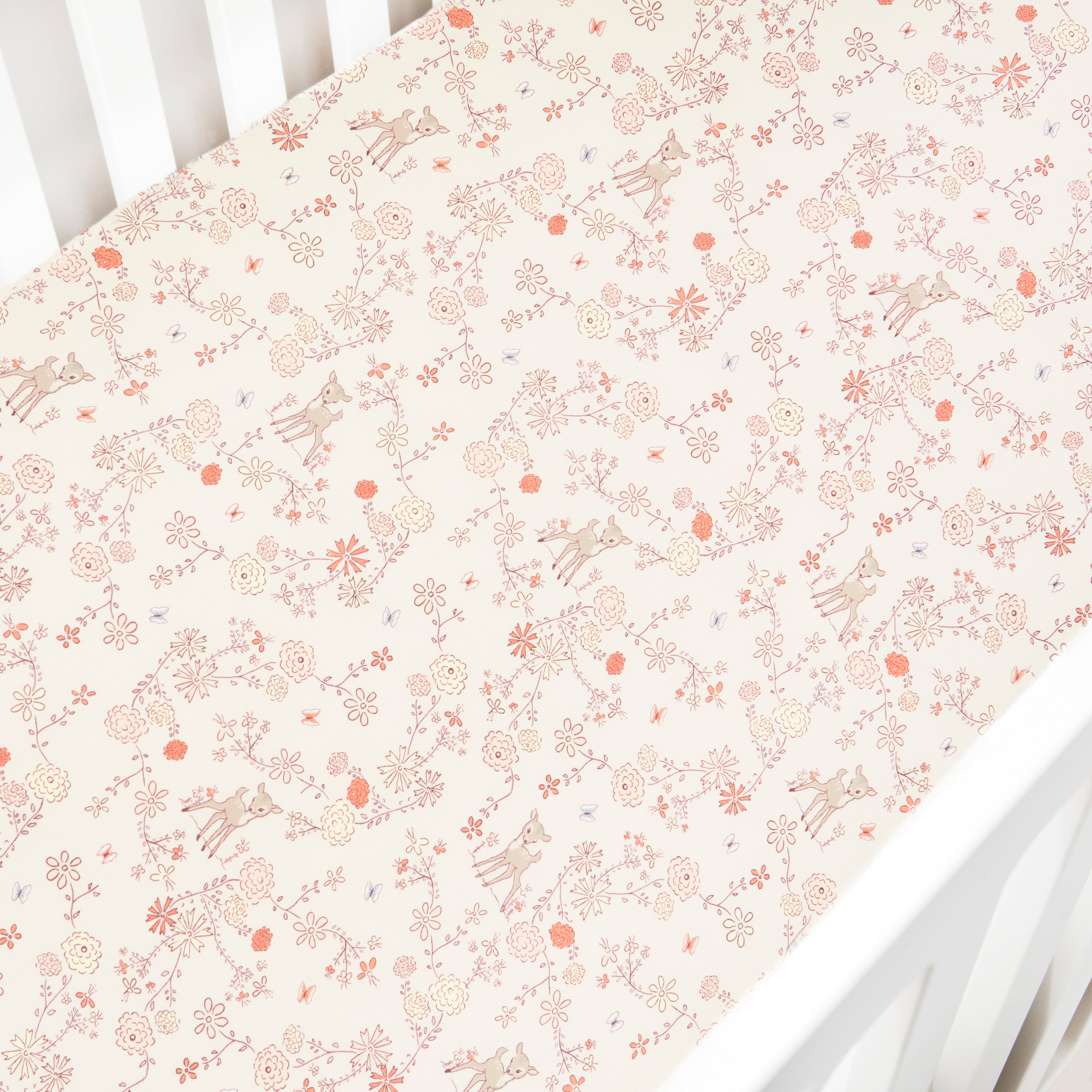 Crib Sheet in "Into The Woodlands" print in the color ivory featured in a crib