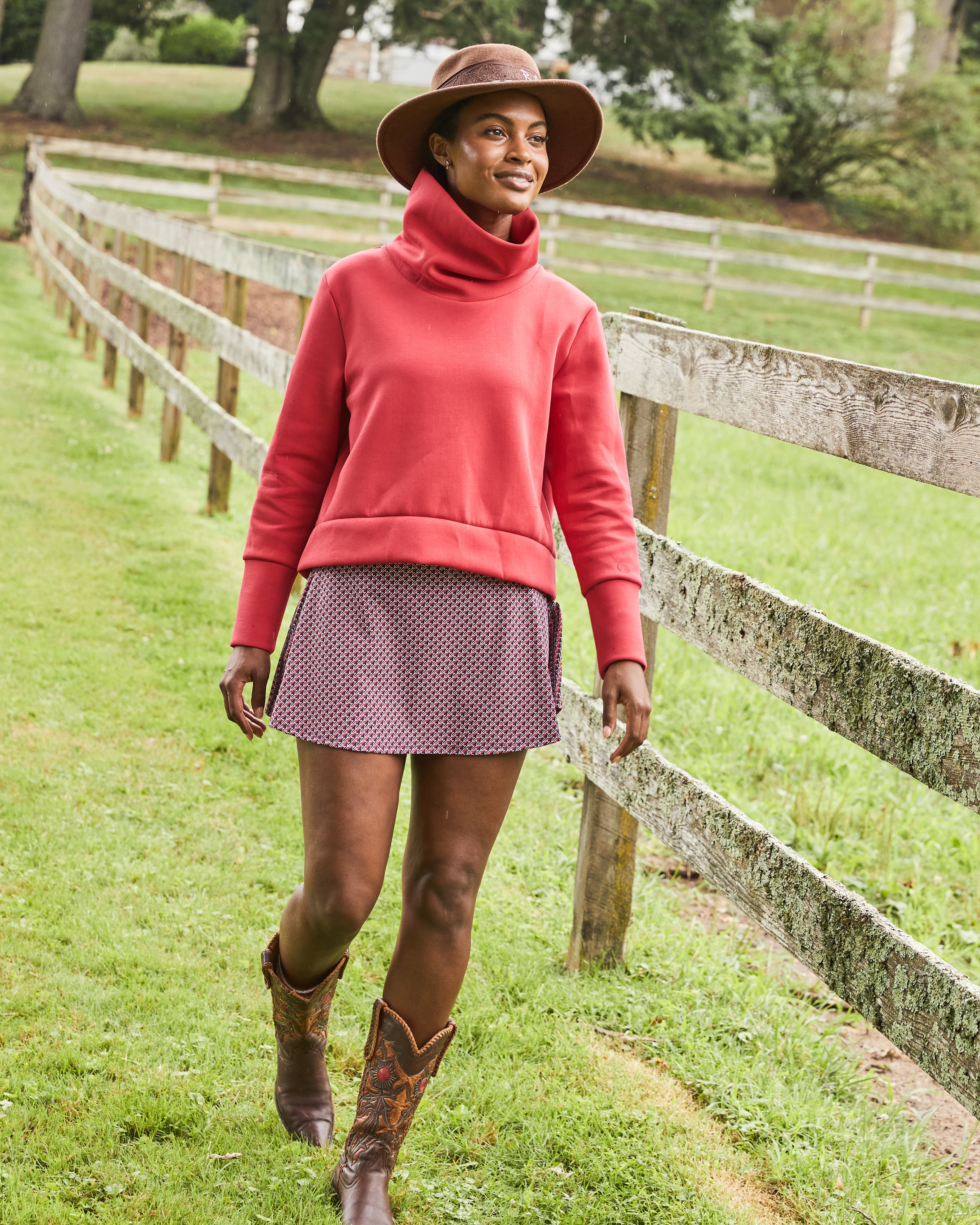 Model is wearing the Everyother Day Pullover in Cherry with the Flounce Skort in Navy/ Cherry stars