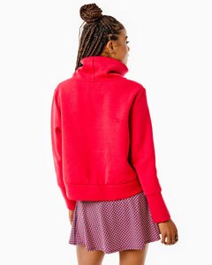 Model is wearing the Everyother Day Pullover in Cherry with the Flounce Skort in Navy/ Cherry stars