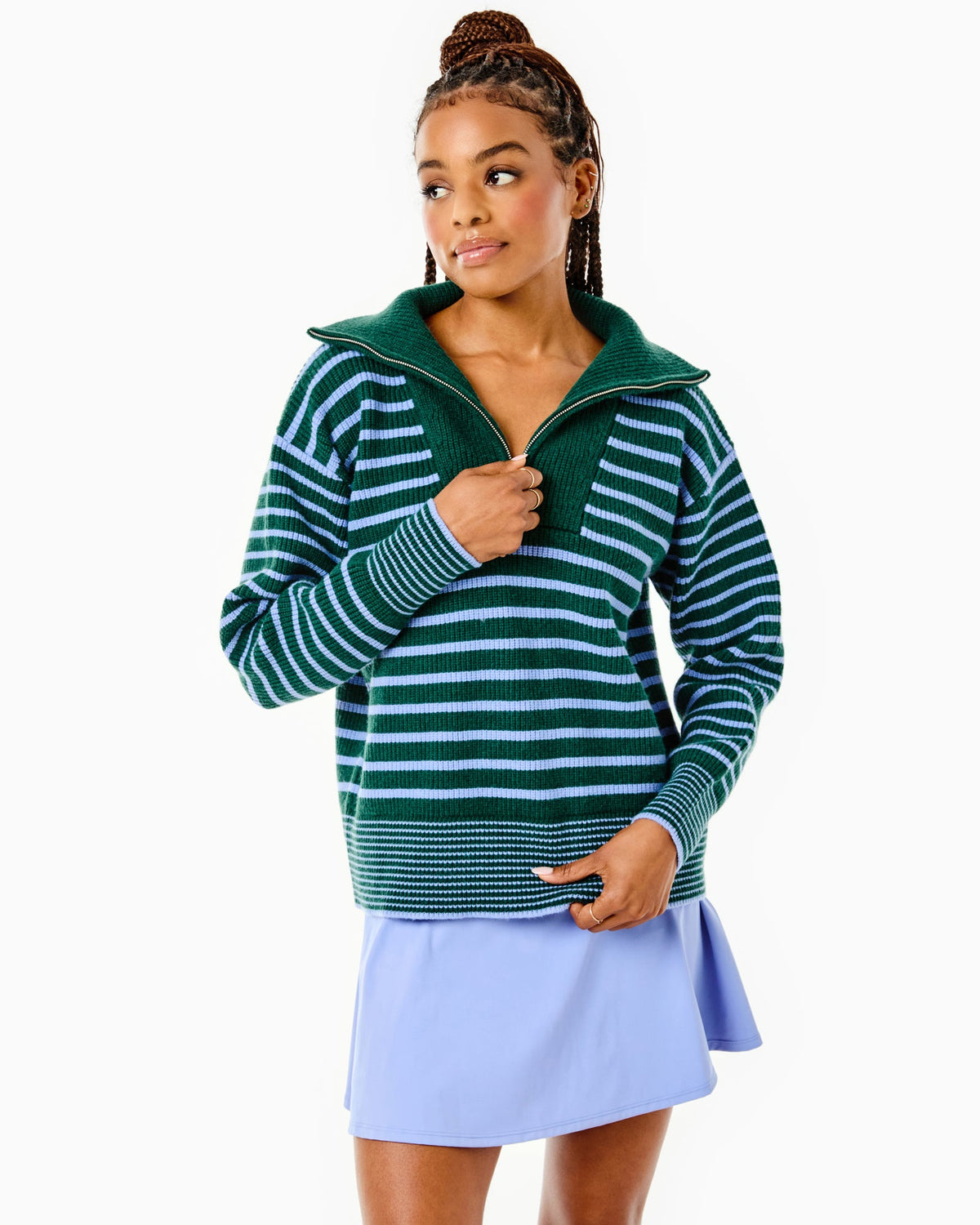 Model is wearing the Griffin Quarter Zip in Ivy/ Violet Stripe with the Flounce Skort in Violet