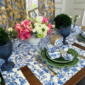 Toile de Jouy hand block printed blue bird placemats shown with matching runner and Bordello Pinehero cabbage plates , matching Toile napkin and gold bird napkin ring. 