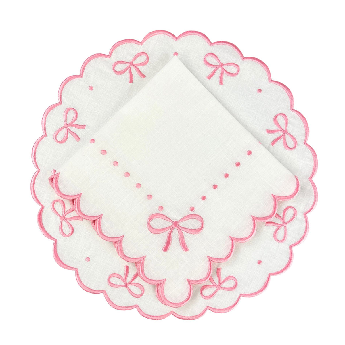 White linen placemat with pink embroidery with bow motif and matching napkin