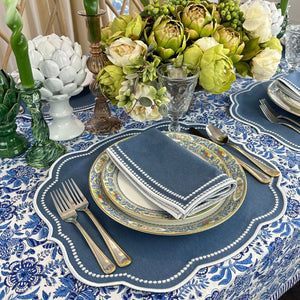 Autumn blue placemat with white embroidery and matching napkin and blue floral  tablecloth 