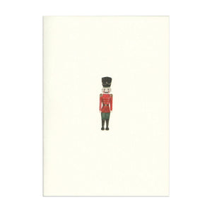 Luxury Christmas Card by Memo Press with a watercolour illustration of a Nutcracker solider and comes with a green envelope made in Britain