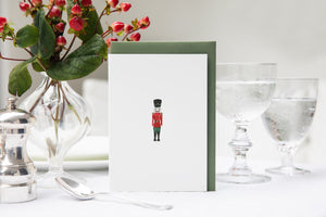 Luxury Christmas Card by Memo Press with a watercolour illustration of a Nutcracker solider and comes with a green envelope made in Britain