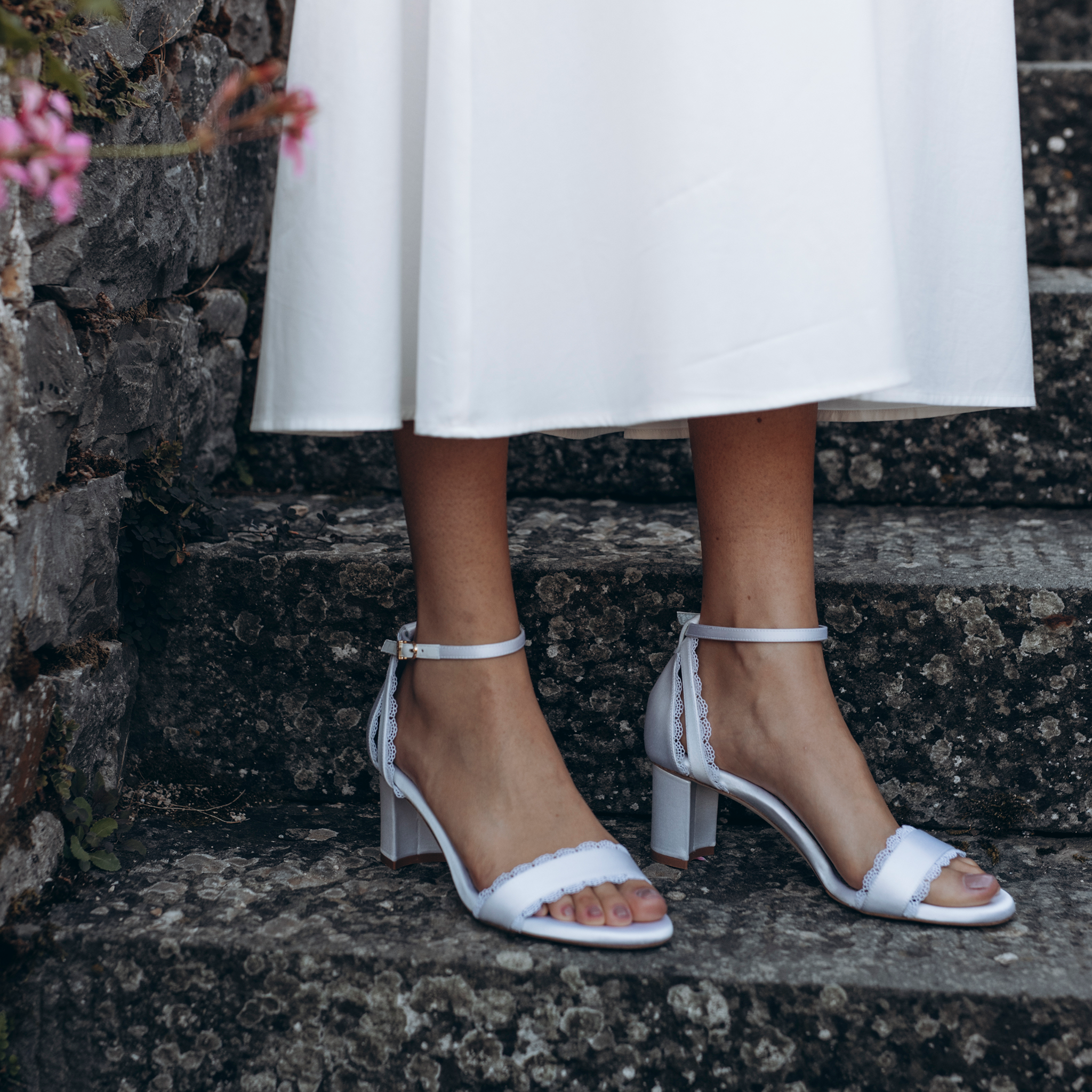 Stylish and comfortable, the Perfect Block Sandal 60 in Wedding White Satin features a 60mm block heel, arch support, and adjustable ankle straps.