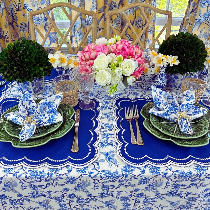 Toile de Jouy Tablecloth with cranes, and the blue Audrey luxury embroidered placemats in blue, bird gold napkin rings on bordello pinhero cabbage plates.