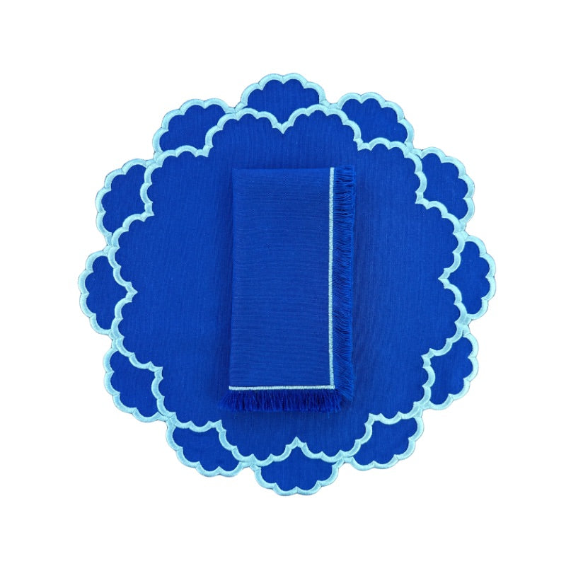 Royal blue placemat with light blue embroidery and coordinating blue fringe napkin 