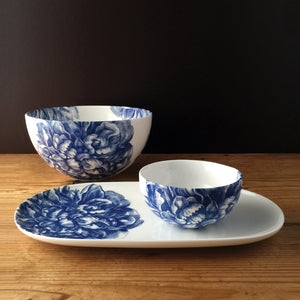 Two Peony Blue snack bowls from Caskata Artisanal Home on a wooden table.